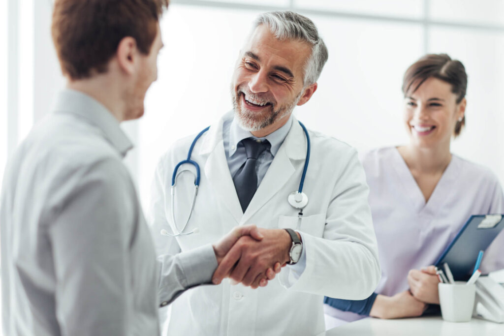 A provider meeting with a patient, along with his Med Aid.