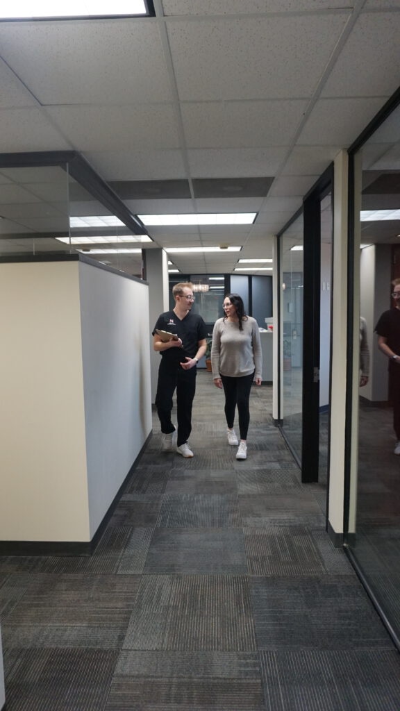 Our staff is also looking for ways to help patients, here is a picture of Izaak walking in a hallway with a patient going over their visit.