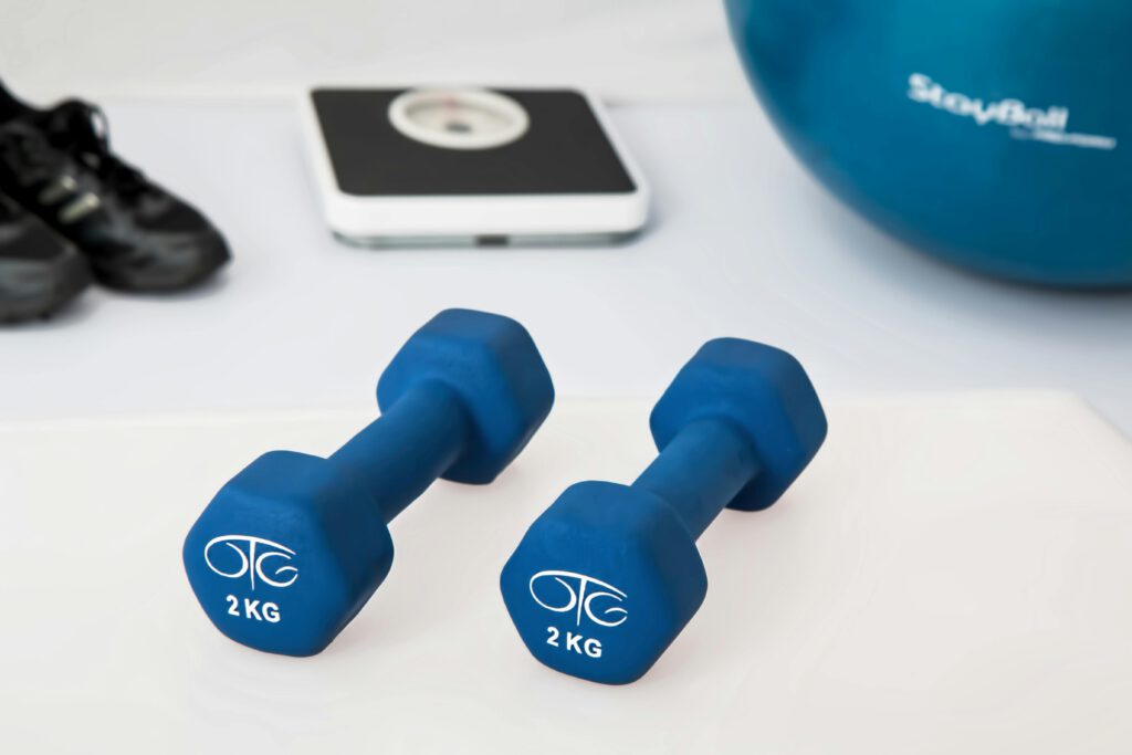 Along a patient's weight loss and wellness journey they will need to manage their diet, fitness levels. Here are workout equipment, like a medicine ball, dumbbells, and a scale. 